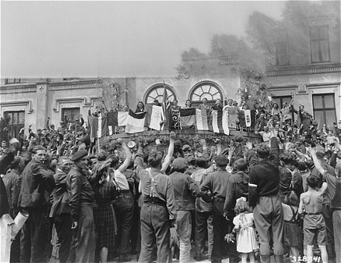 "Displaced Persons" (DPs) Take Part in a Flag Ceremony (1945)