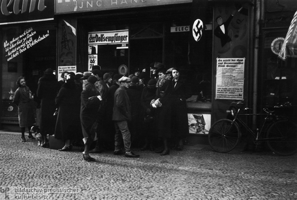 Passersby in Front of a Berlin Radio Store Listen to the Official Radio Broadcast of a Speech by Hitler (1936)